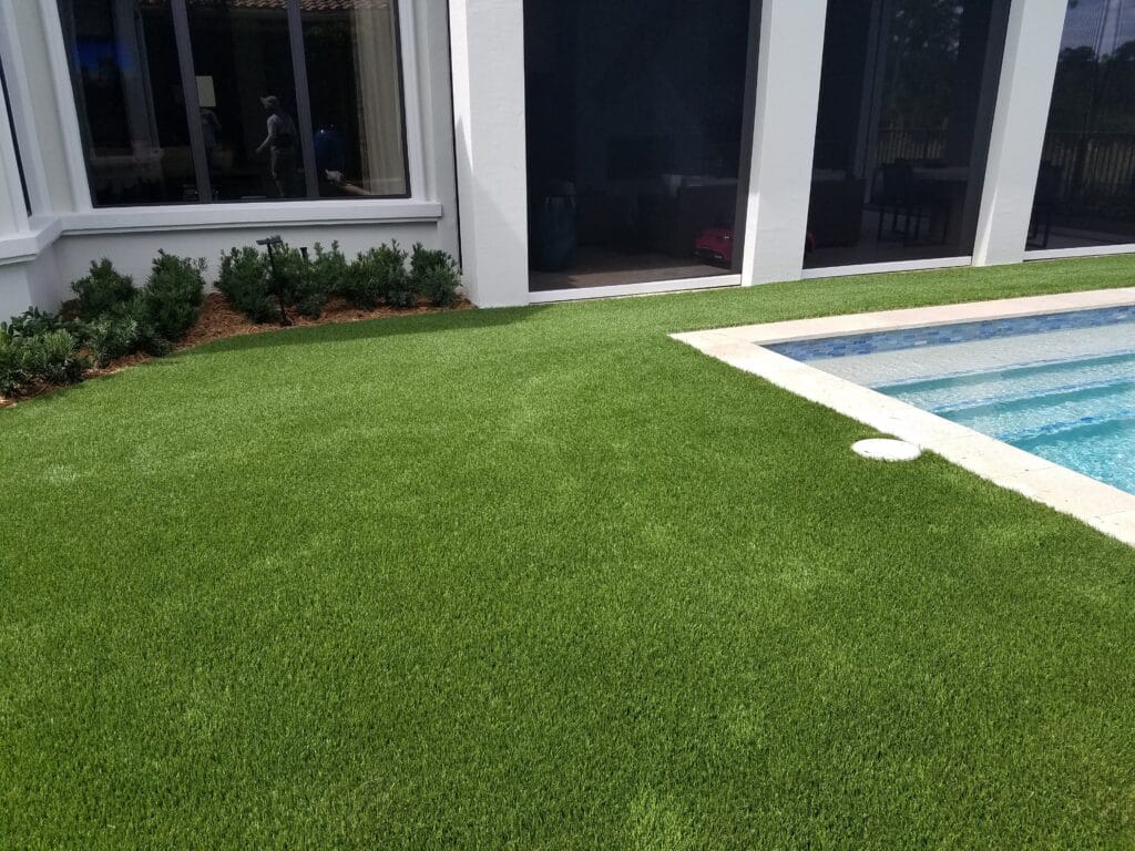 a pool in a grass field smart synthetic turf
