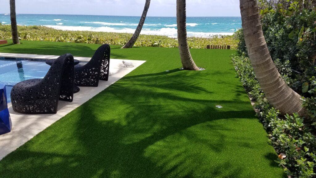 a lawn with palm trees and chairs smart synthetic turf