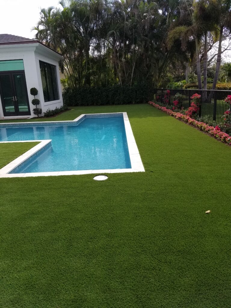 a pool in a green turf yard smart synthetic turf