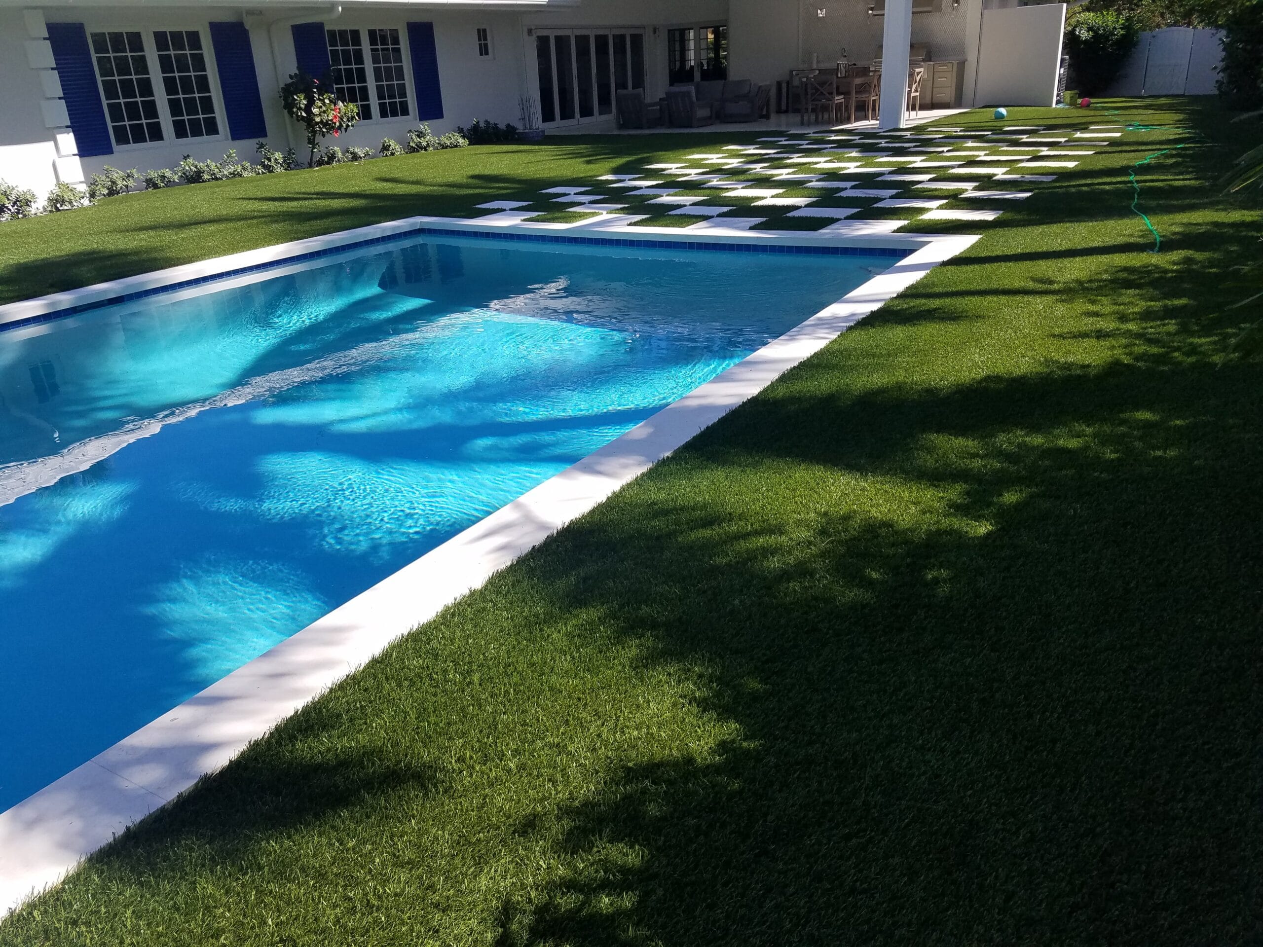 a pool in a yard smart synthetic turf